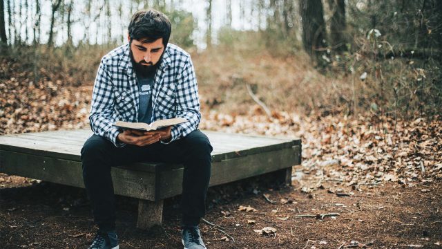 man-reading-his-bible-in-the-woods-MQUPR6B-web